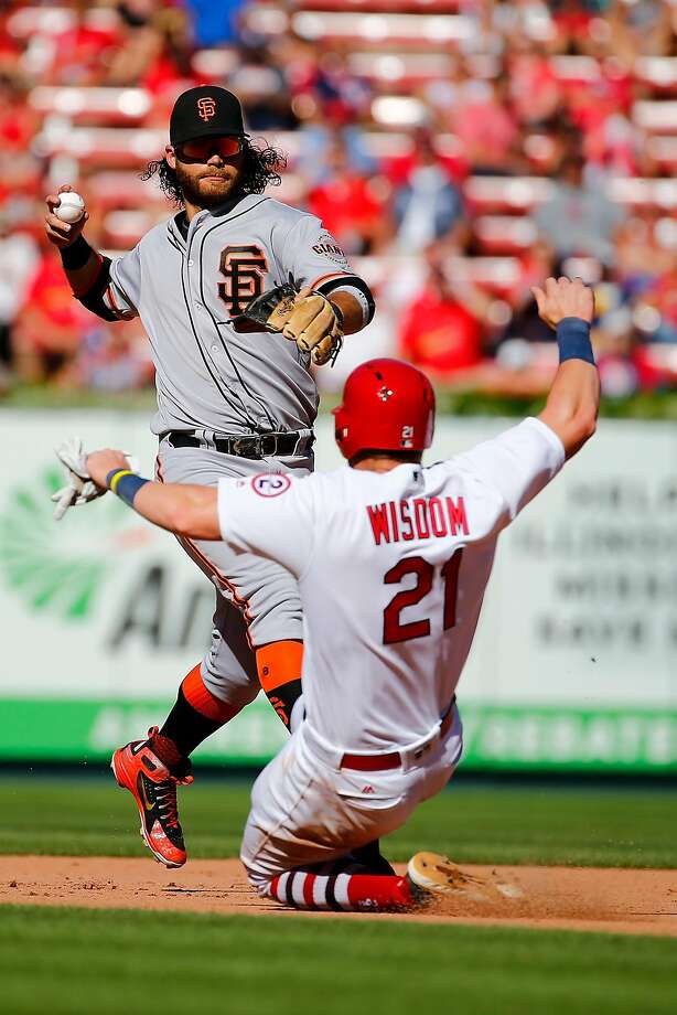 ST. LOUIS, MO - SEPTEMBER 23: Brandon Crawford #35 of the San Francisco Giants turns a double play over Patrick Wisdom #21 of the St. Louis Cardinals in the seventh inning at Busch Stadium on September 23, 2018 in St. Louis, Missouri.  (Photo by Dilip Vishwanat/Getty Images) Photo: Dilip Vishwanat, Getty Images