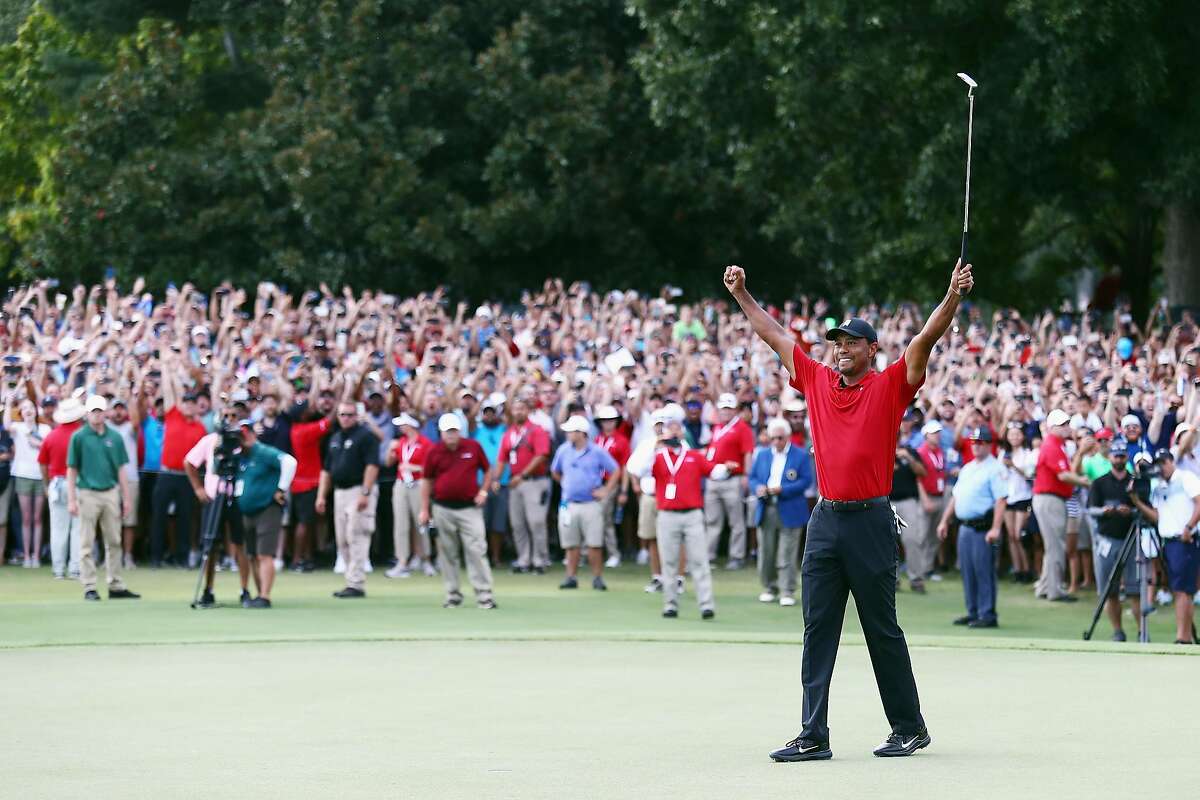 ATLANTA, GA - SEPTEMBER 23: Tiger Woods of the United States celebrates making a par on the 18th green to win the TOUR Championship at East Lake Golf Club on September 23, 2018 in Atlanta, Georgia. (Photo by Tim Bradbury/Getty Images)