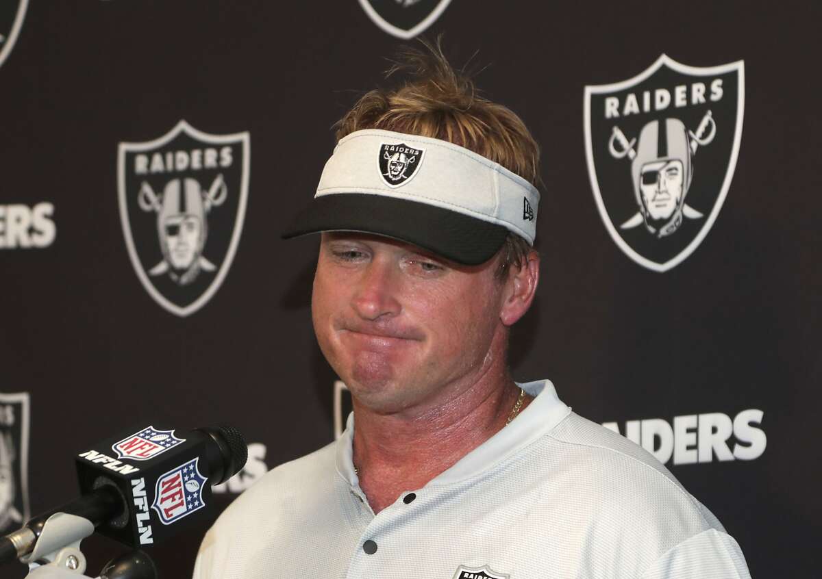 Oakland Raiders head coach Jon Gruden talks with center Rodney Hudson (61)  and quarterback Derek Carr, left rear, during the second half of an NFL  football game against the Miami Dolphins, Sunday, …