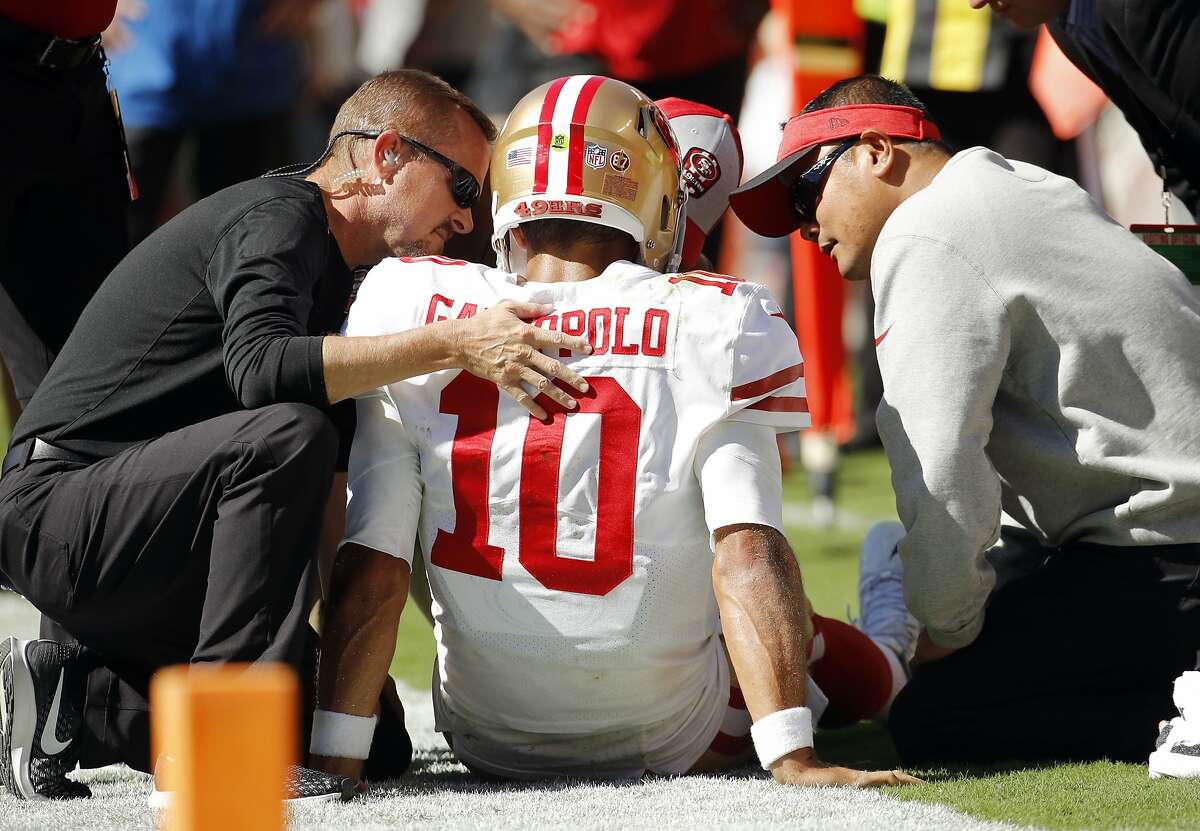 FILE - Trainers attend to San Francisco 49ers quarterback Jimmy Garoppolo (10) who was injured after a tackle by Kansas City Chiefs defensive back Steven Nelson during the second half of an NFL football game in Kansas City, Mo., Sunday, Sept. 23, 2018.