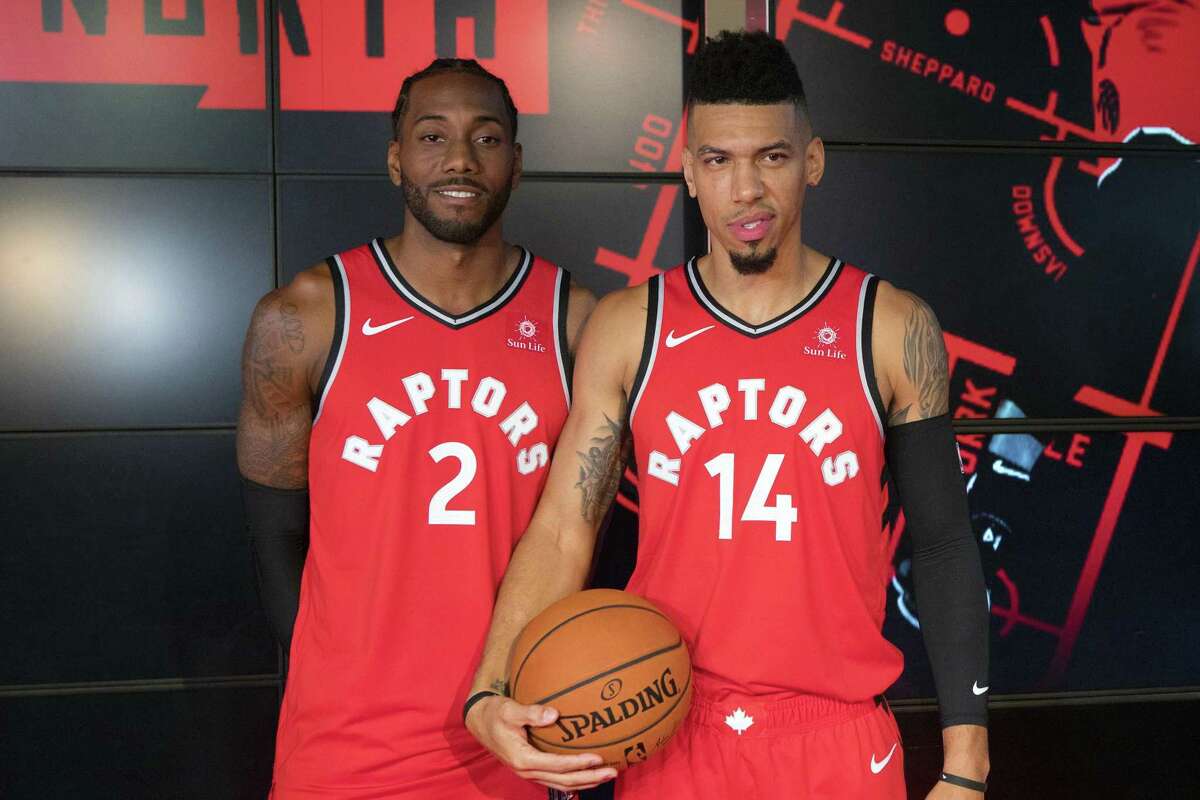 Toronto Raptors NBA basketball players Kawhi Leonard, left, and Danny Green pose for a photo during media day in Toronto, Monday, Sept. 24, 2018. (Chris Young/The Canadian Press via AP)