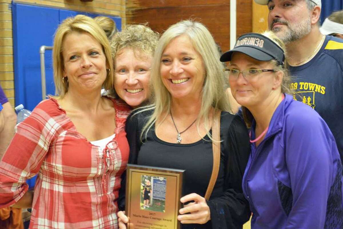 Julie Aresco of Middletown, center, is flanked by fellow Run 169ers, from left, Doreen Laliberte, Sherri Condon, and to her right, Celeste Fong and Sergio De Sousa at the ceremony during which she was presented the Mario Hasz Courage Award. Areso, who has a TBI from a work-related accident, is running the Eversource Hartford Half Marathon Oct. 13.