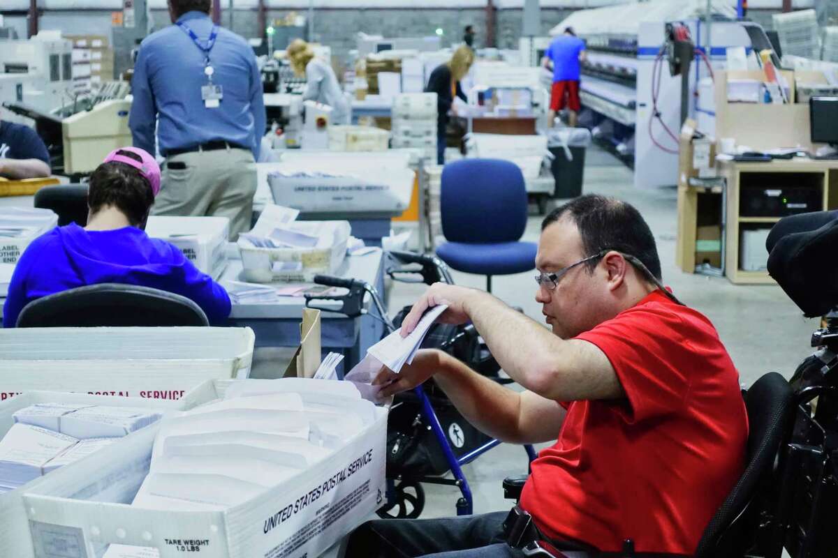 Rich Whaley, a mail processing clerk at the Center for Disability Services mail fulfillment center, works on a job at the center on Tuesday, Sept. 25, 2018, in Albany, N.Y. (Paul Buckowski/Times Union)