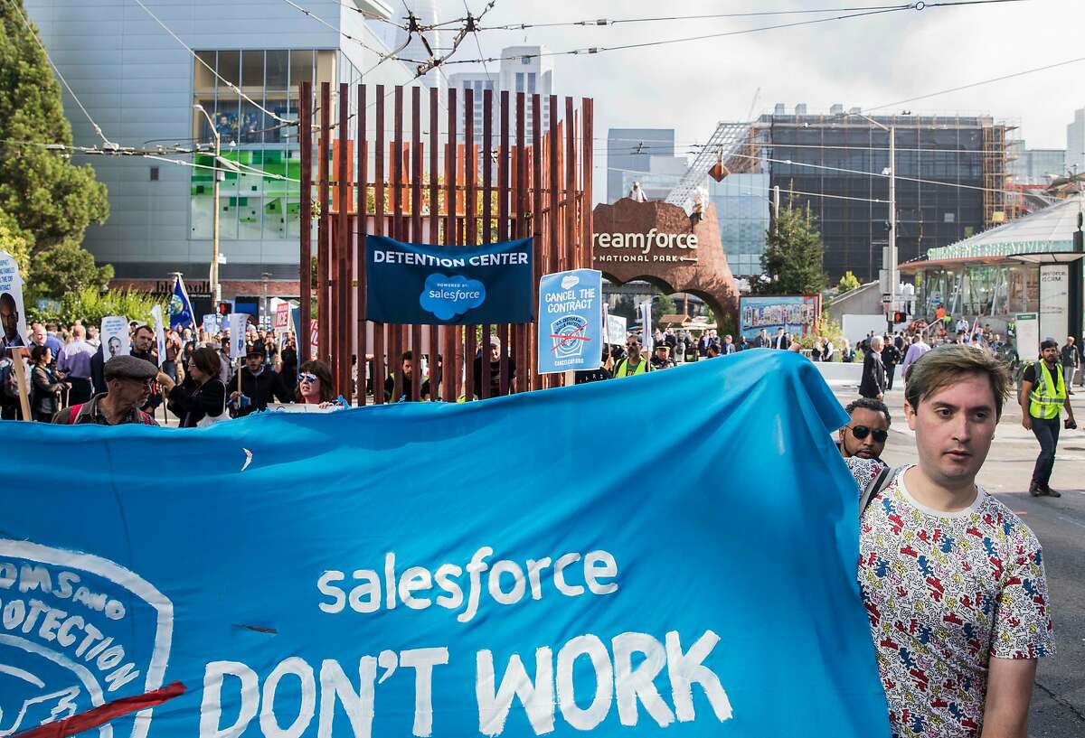Protesters with Fight for the Future walk down 4th Street with a large cage installation calling for an end to Salesforce's contract with Customs and Border Patrol outside the Dreamforce conference hosted by Salesforce in downtown San Francisco, Calif. Tuesday, Sept. 25, 2018.