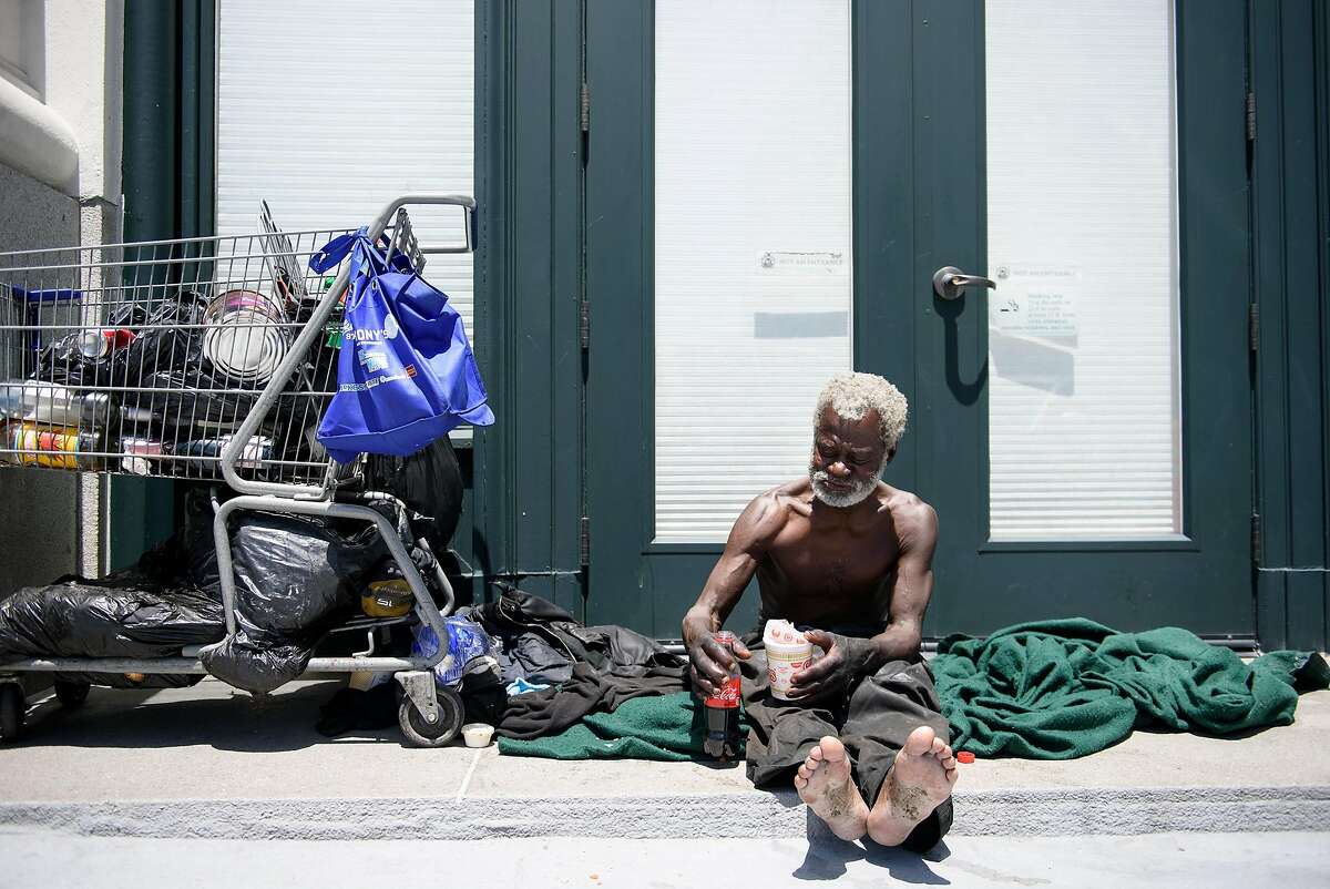 Jerry Womack, who has been homeless for 8 years, eats some food as he sits in a doorway on Van Ness Street near Market in San Francisco, Calif., on Thursday May 31, 2018.