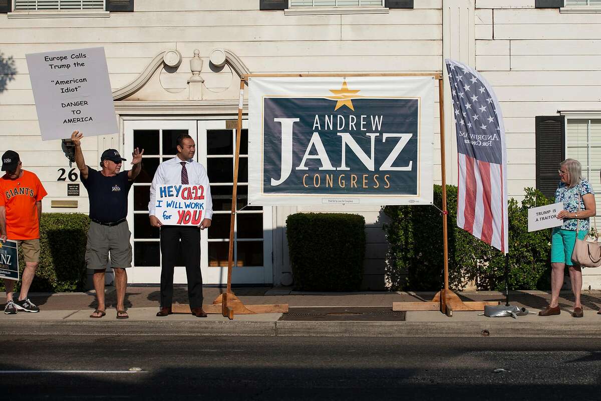 CLOVIS, CA - JULY 17: Andrew Janz, 3rd from left, stands with supporters during the "Every Tuesday Vigil" outside the office of Rep. Devin Nunes (R-CA) on July 17, 2018 in Clovis, California. The vigil, held by Janz supporters takes place every Tuesday outside of the office of Nunes. Janz is hoping to unseat Nunes in the November Congressional election. (Photo by Alex Edelman/Getty Images)