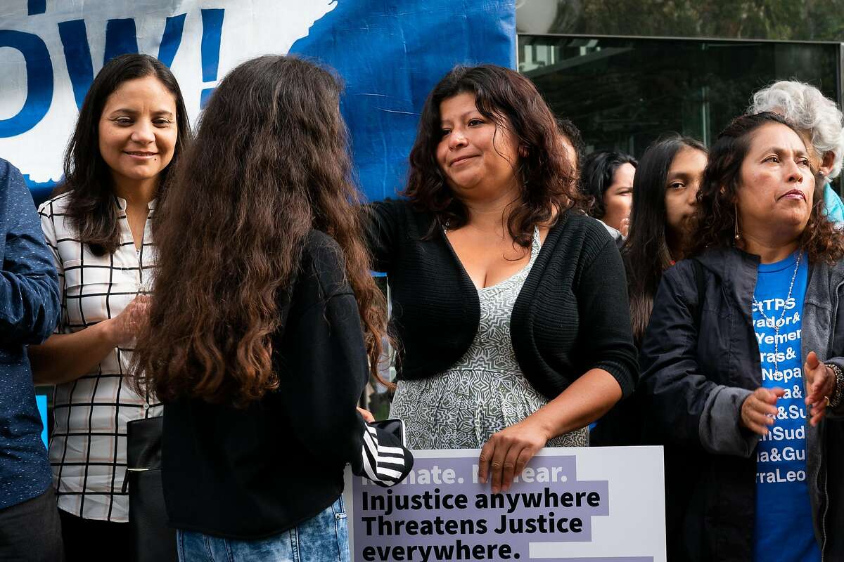 Cristina Morales (center) smiles at her daugher, Crista Ramos, 14, the lead plaintiff in the Ramos v. Neilsen lawsuit, during a press conference requesting temporary injunction of the Trump administration's decision to end Temporary Protected Status (TPS) for people from four countries, including Sudan, Nicaragua, Haiti and El Salvador at Phillip Burton Federal Building in San Francisco on Tuesday, September 25, 2018.