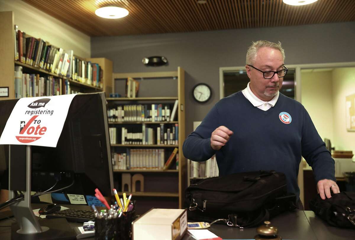 Director of library services Dean James gets the front desk ready for voter registration at Alliant International University Hurwich Library near pier 39 on Tuesday, Sept. 25, 2018 in San Francisco, Calif. National Voter Registration Day is today and the big push before the November mid-term election begins.