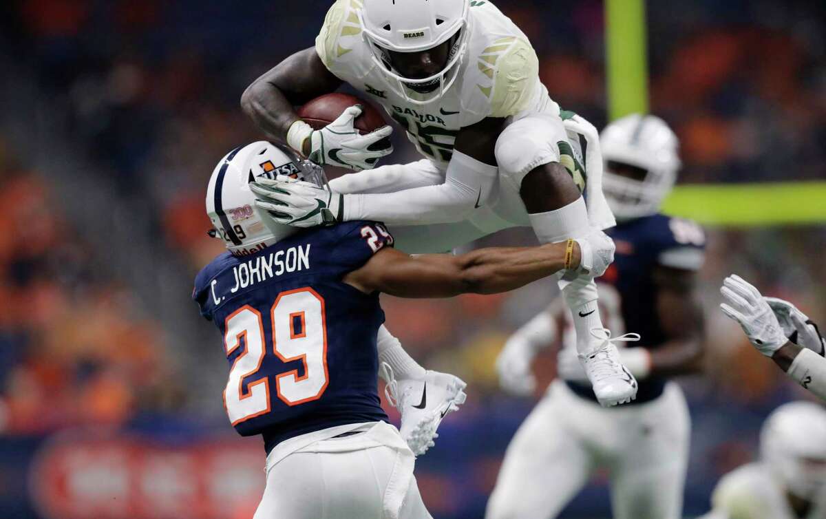 Baylor wide receiver Denzel Mims (15) tries to leap over UTSA cornerback Clayton Johnson (29) after making a catch during the second half of an NCAA college football game, Saturday, Sept. 8, 2018, in San Antonio. (AP Photo/Eric Gay)