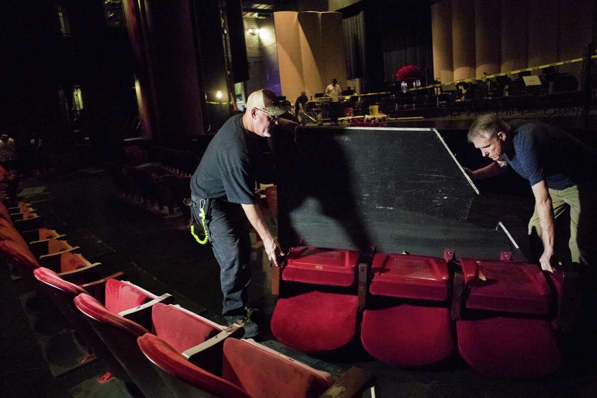 Stagehands place place temporary seats on top of the covered orchestra pit in the Brown Theater, in preparation for Houston Grand Opera’s gala performance Wednesday.