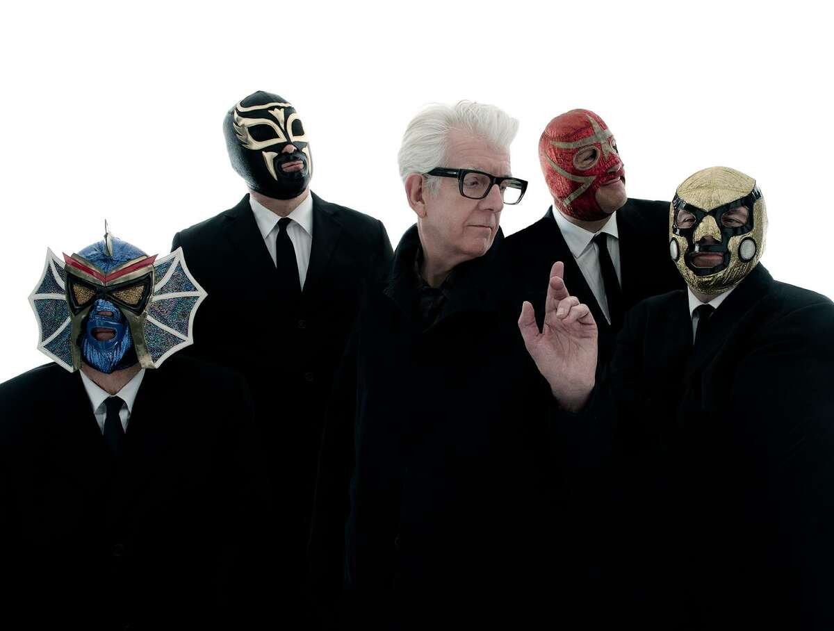 Singer and songwriter Nick Lowe pictured with rockabilly band Los Straightjackets.