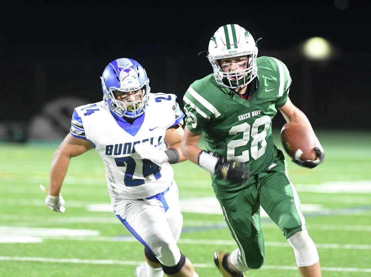 New Milford’s Johnny Fitzmaurice (28) right, is pursued by Bunnell’s Nick Ochoa.