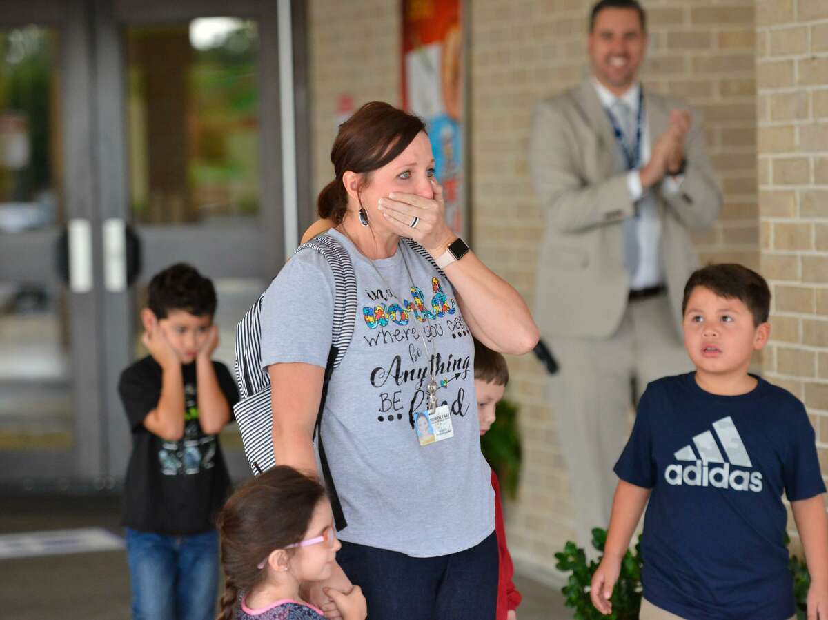 Northern Hills Elementary School teacher Ginger Cunningham reacts after she was awarded a check for $5,141 from the NEISD Education Foundation on Wednesday morning.