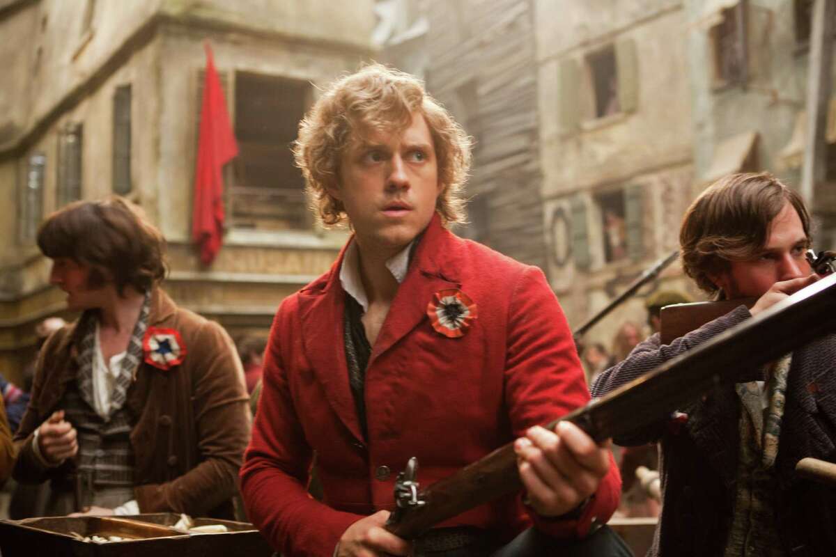Aaron Tveit as Enjolras (center) leads the student rebellion in “Les Misérables.”