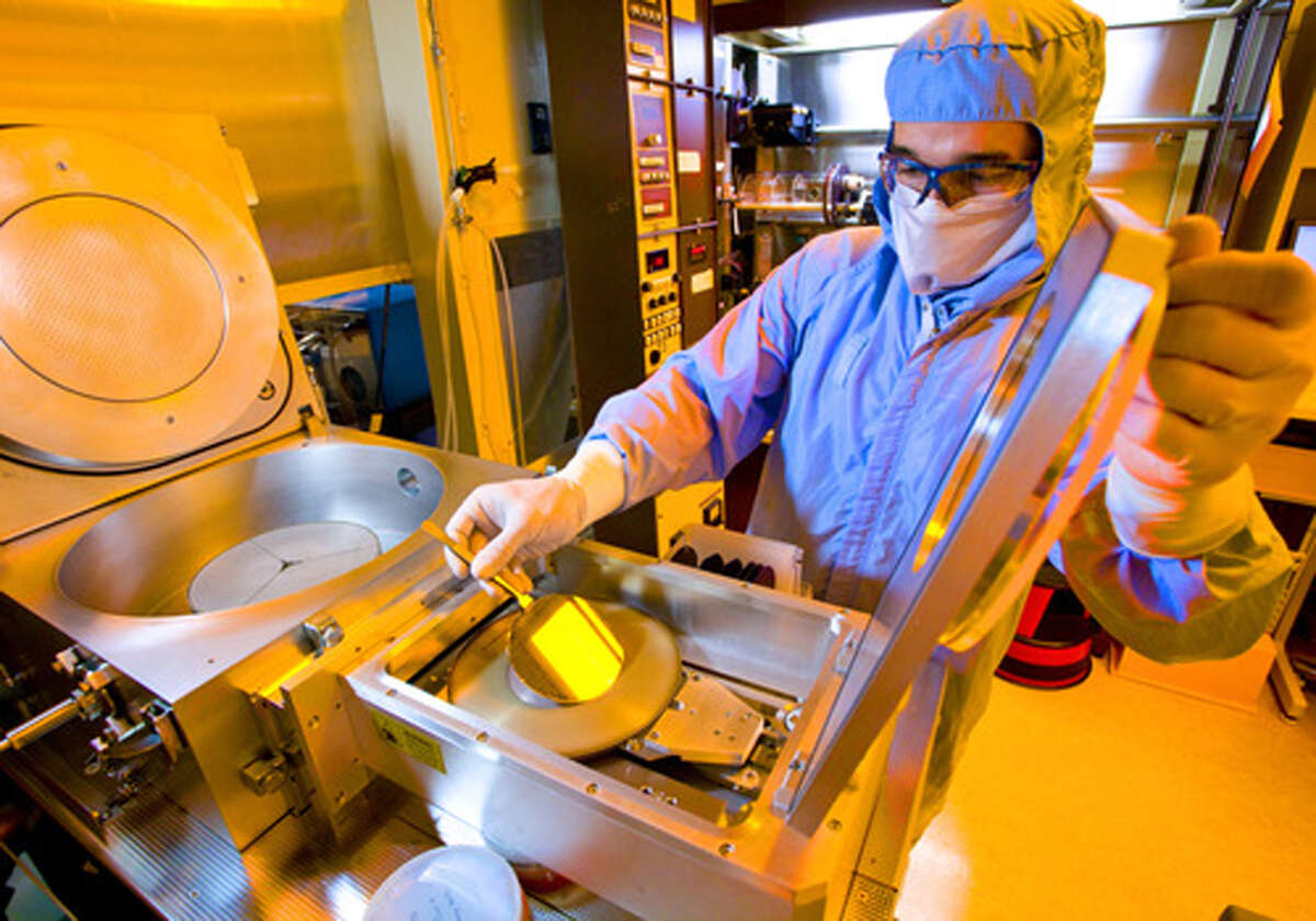 A GE worker with silicon carbide wafers at the company's research lab in Niskayuna. GE is transferring its silicon carbide chip development to SUNY Poly in Albany.