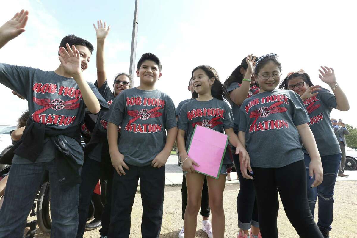 Bob Hope Elementary School students react Wednesday, Sept. 26, 2018 at Bob Hope Elementary School the roar wash created as an AirLife helicopter takes off from the school. Some of the school's students toured the helicopter after a press conference where the Southwest ISD announced the creation of a pre-k through 12th grade aeronautical program the district is starting.