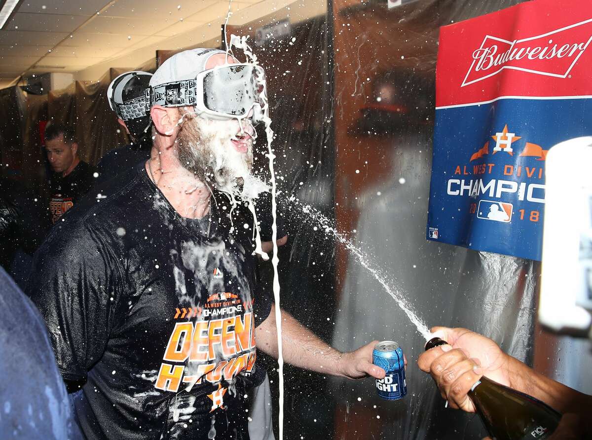 TORONTO, ON - SEPTEMBER 26: Brian McCann #16 of the Houston Astros celebrates in the clubhouse after the Astros clinched the American League West division title after their MLB game against the Toronto Blue Jays at Rogers Centre on September 26, 2018 in Toronto, Canada. (Photo by Tom Szczerbowski/Getty Images)