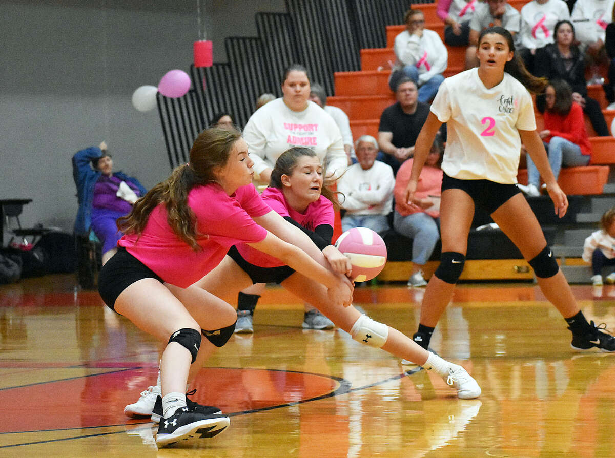 Edwardsville’s Jillian Allen, left, and Kaitlyn Conway try to receive a serve during the first game against Cor Jesu on Wednesday inside the Lucco-Jackson Gymnasium.