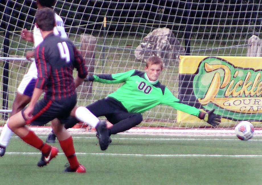 Alton’s Blake Dunse (4) puts the ball just beyond the reach of Mascoutah goalie Stephen Schulte and scores during Wednesday’s CYC Soccer Tournament pool play game at World Wide Technology Soccer Park in Fenton. Alton won 9-0. Photo: Pete Hayes | The Telegraph