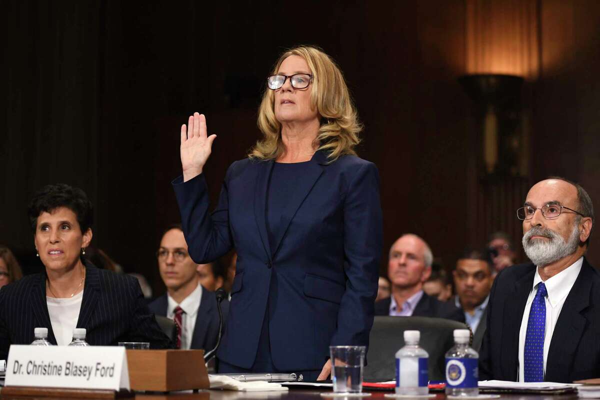 Christine Blasey Ford is sworn in to testify before the Senate Judiciary Committee on Capitol Hill in Washington, Thursday, Sept. 27, 2018, as her attorney's Debra Katz and Michael Bromwich watch. (Saul Loeb/Pool Photo via AP)