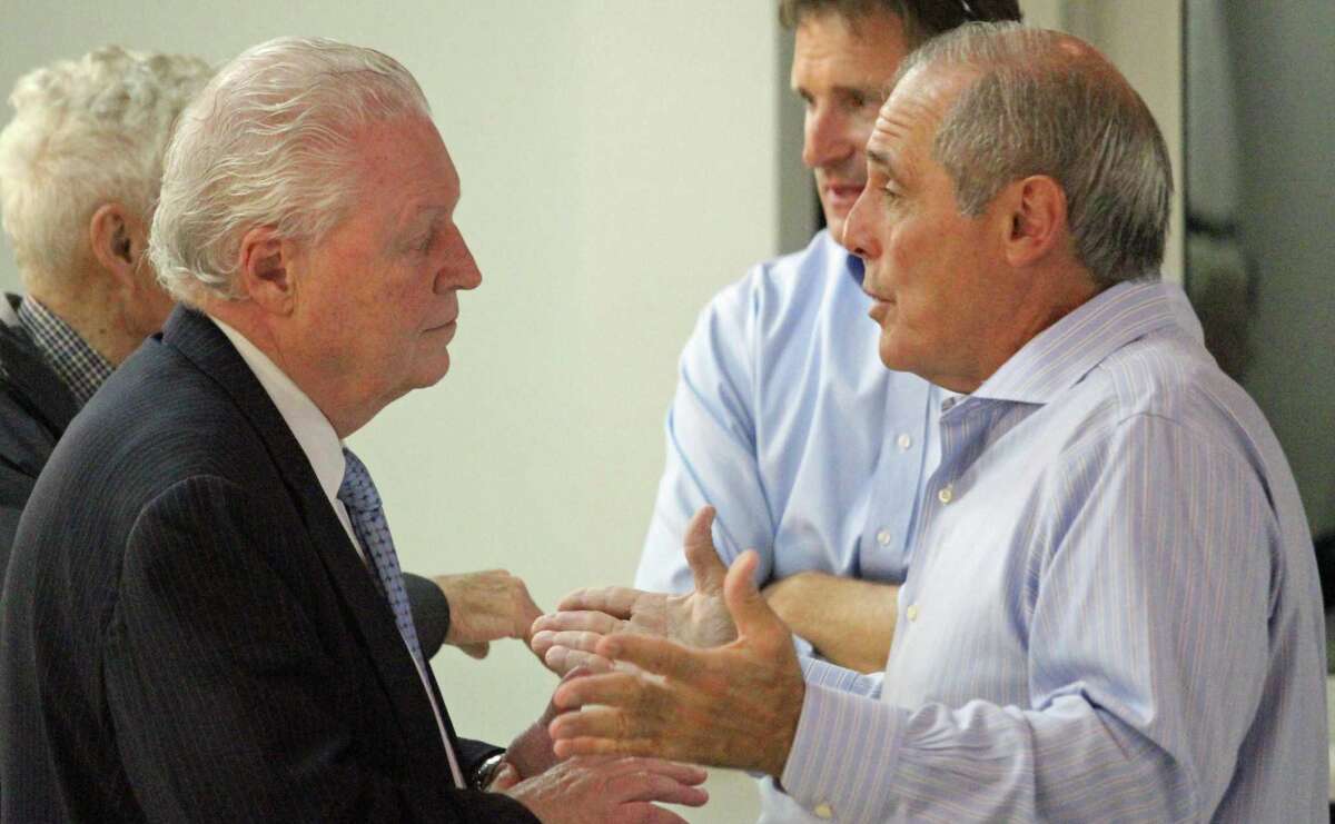 First Selectman Mike Tetreau, left, talks with local developer Michael Schinella prior to the start of a meeting on transit-oriented development.