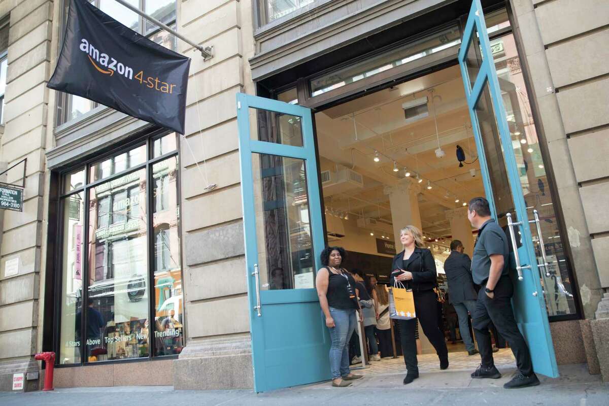 A shopper leaves the Amazon 4-star store in the Soho neighborhood of Manhattan after making a purchase, Thursday, Sept. 27, 2018. 