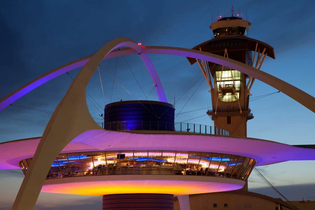 Theme Building and tower of Los Angeles International Airport at dusk.