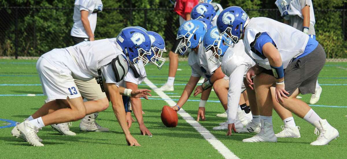 The Darien offensive line faces off against the defense in a practice on Thursday.
