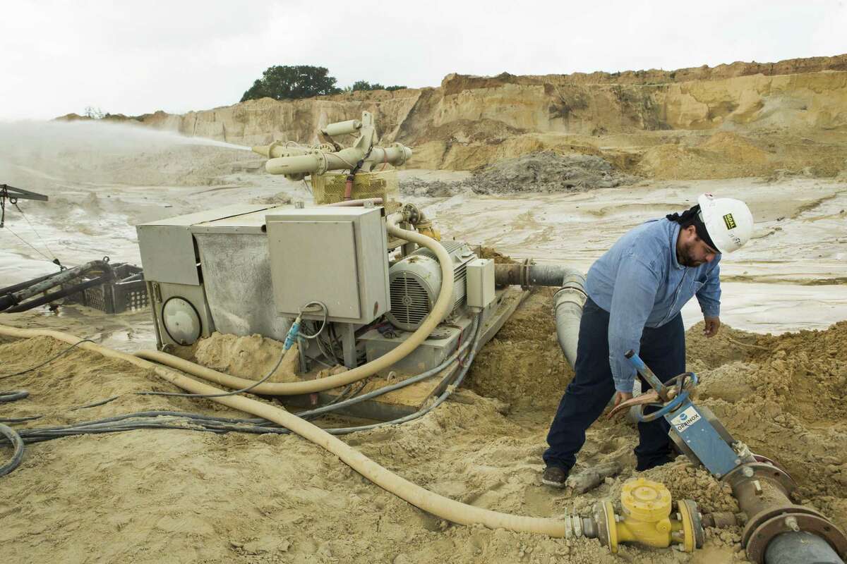 Julio Griffin adjusts the water pressure on a hydro-cannon at the Superior Silica Sands sand mine on Tuesday, March 28, 2017, in Kosse, Texas. Demand for sand is surging as oil and gas production in the Permian Basin is booming again. Not only is the need for more sand on the rise with the increase in oil and gas production in west Texas, but much more sand is being pumed into each well now withi the emerging thesis that more sand equals more oil extracted. ( Brett Coomer / Houston Chronicle )