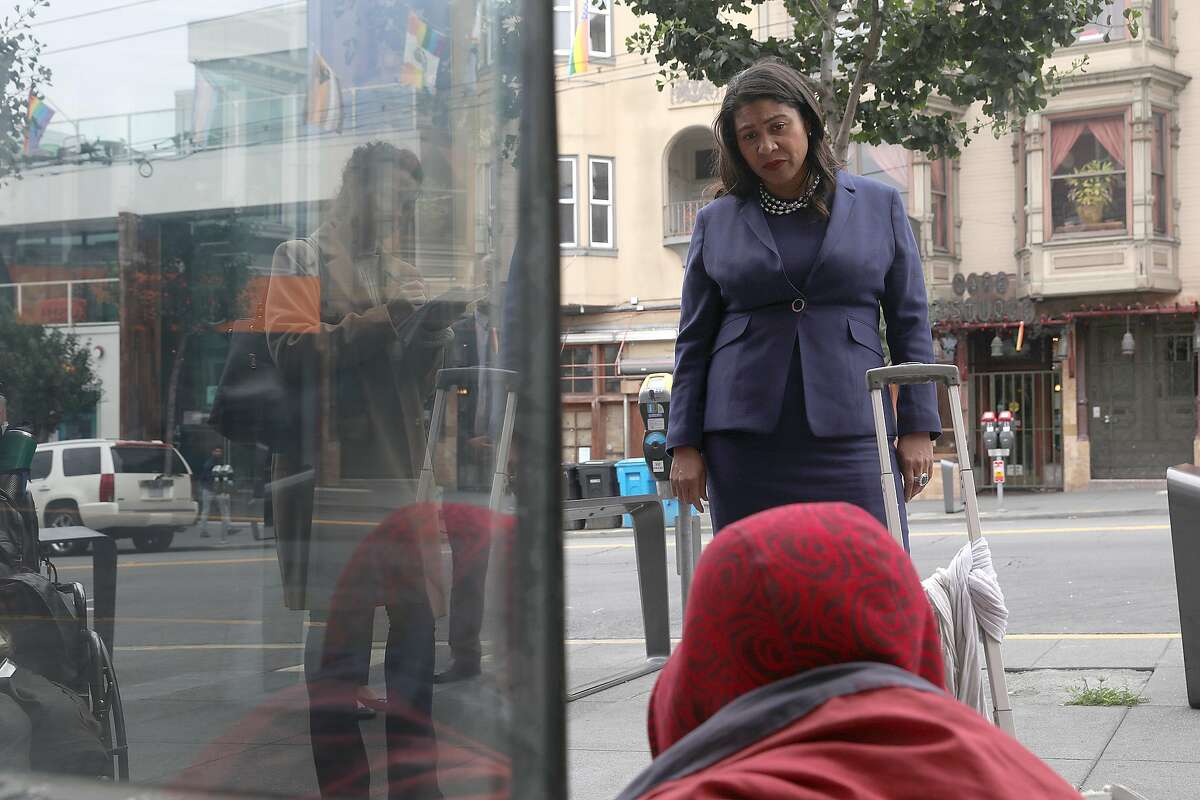 SF Mayor London Breed talks with a homeless man in front of Outfit on Castro Street as she takes a neighborhood walk this morning on Monday, Aug. 13, 2018 in San Francisco, Calif.
