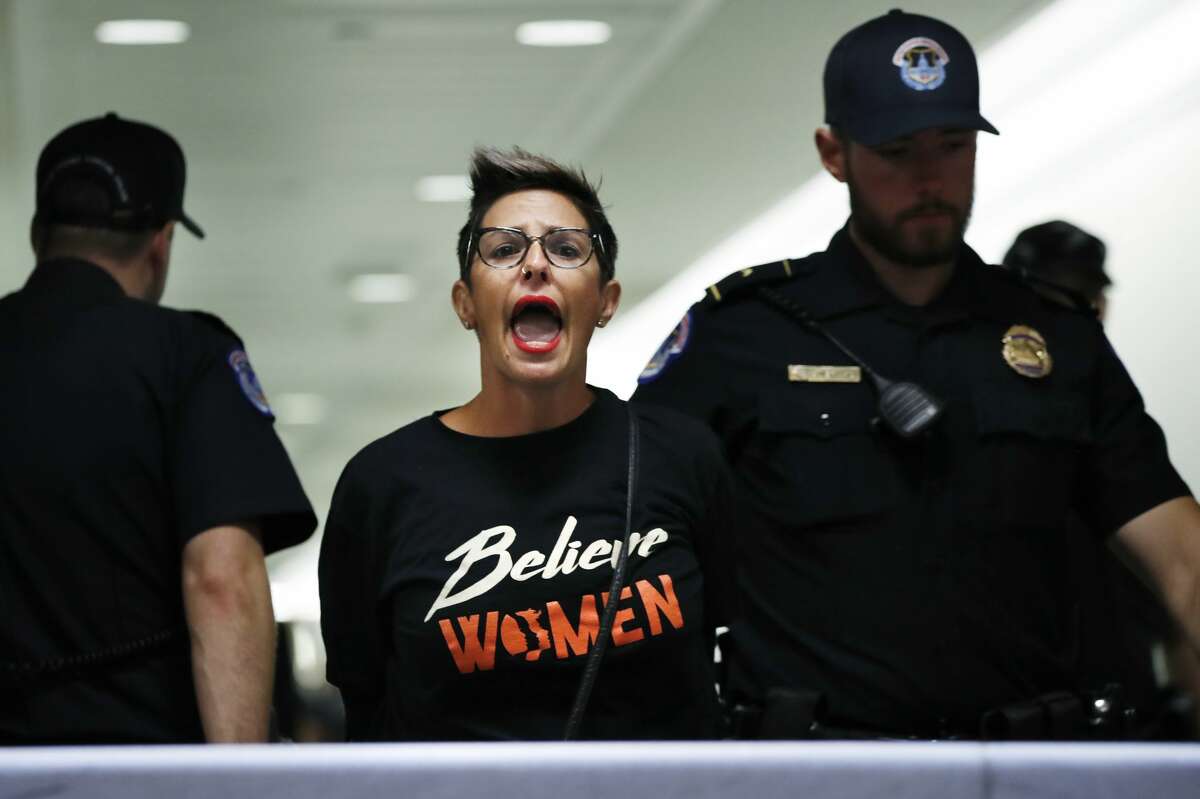 A woman protesting Supreme Court nominee Brett Kavanaugh is removed from the hallway near the Senate Judiciary Committee hearing room after being arrested by Capitol Police, Friday, Sept. 28, 2018, on Capitol Hill in Washington. (AP Photo/Jacquelyn Martin)