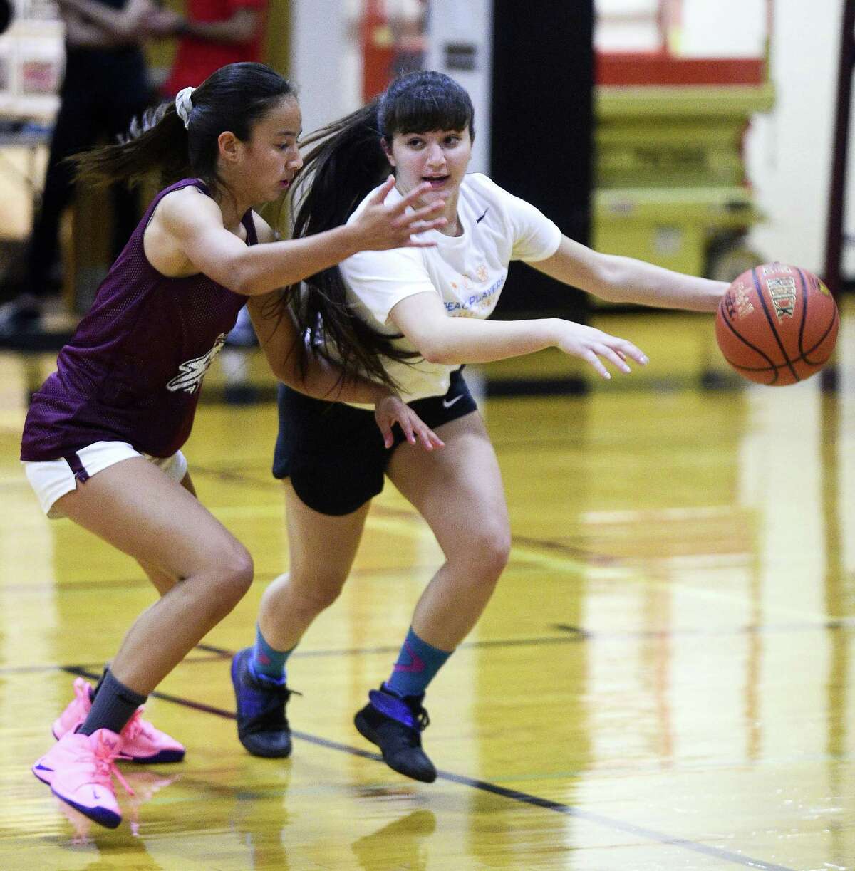 St. Luke's Caroline Lau defends the drive of Jenan Maharmeh of the PeacePlayers-Middle East All Stars during a Goodwill basketball game on Wednesday, Sept. 26, 2018 in New Canaan, Connecticut. A group of Arab and Israeli girls who have grown up playing basketball together in the PeacePlayers Middle East program, have been touring the United States promoting Peace and Goodwill.