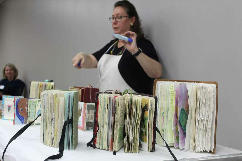 Artist Terri Sanders demonstrates her altered book work at The Woodlands Art League monthly meeting Thursday, Sept. 27 at the South County Community Center along Lake Robbins Drive. Photo: Jane Stueckemann/The Villager / Jane Stueckemann/The Villager