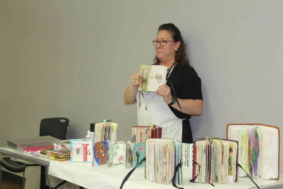 Artist Terri Sanders demonstrates her altered book work at The Woodlands Art League monthly meeting Thursday, Sept. 27 at the South County Community Center along Lake Robbins Drive. Photo: Jane Stueckemann/The Villager / Jane Stueckemann/The Villager