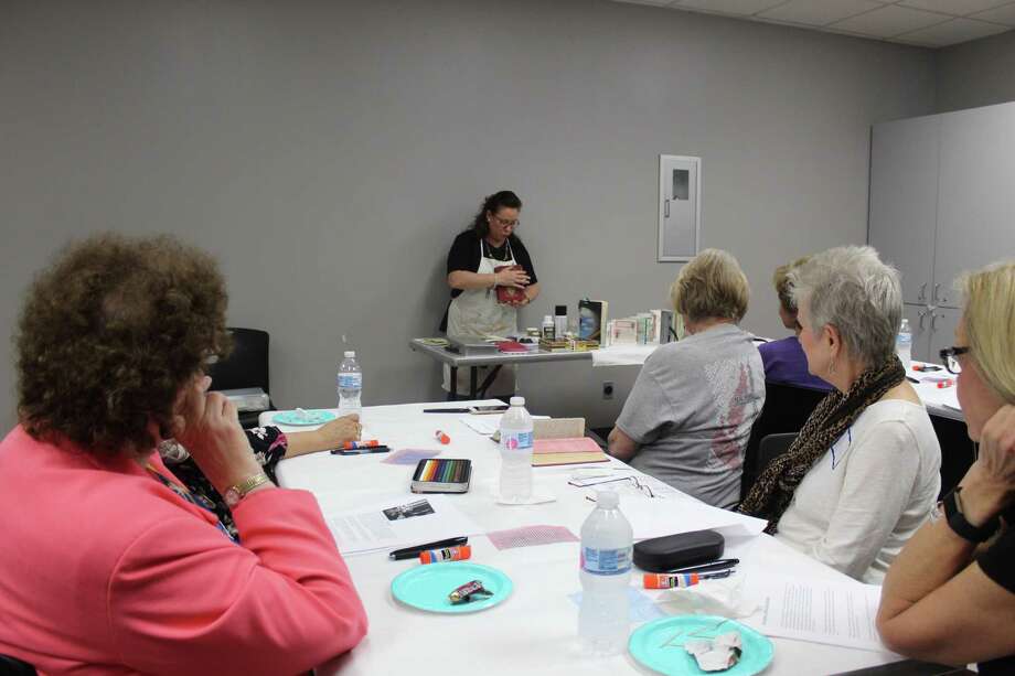 Artist Terri Sanders demonstrates her altered book work at The Woodlands Art League monthly meeting Thursday, Sept. 27 at the South County Community Center along Lake Robbins Drive. Photo: Jane Stueckemann/The Villager / Jane Stueckemann/The Villager