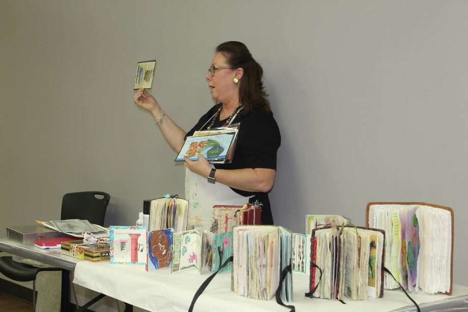 Artist Terri Sanders demonstrates her altered book work at The Woodlands Art League monthly meeting Thursday, Sept. 27 at the South County Community Center along Lake Robbins Drive. Photo: Jane Stueckemann/The Villager / Jane Stueckemann/The Villager