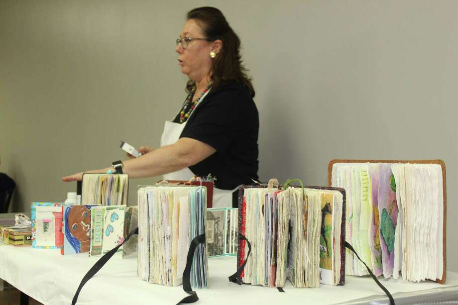 Artist Terri Sanders demonstrates her altered book work at The Woodlands Art League monthly meeting Thursday, Sept. 27 at the South County Community Center along Lake Robbins Drive. Photo: Jane Stueckemann/The Villager / Jane Stueckemann/The Villager