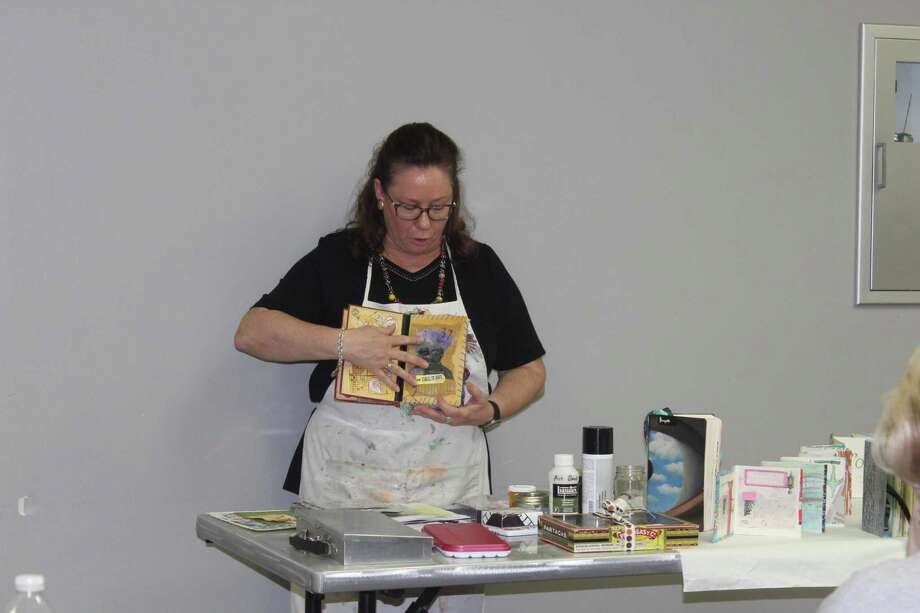 Artist Terri Sanders demonstrates her altered book work at The Woodlands Art League monthly meeting Thursday, Sept. 27 at the South County Community Center along Lake Robbins Drive. Photo: Jane Stueckemann/The Villager / Jane Stueckemann/The Villager