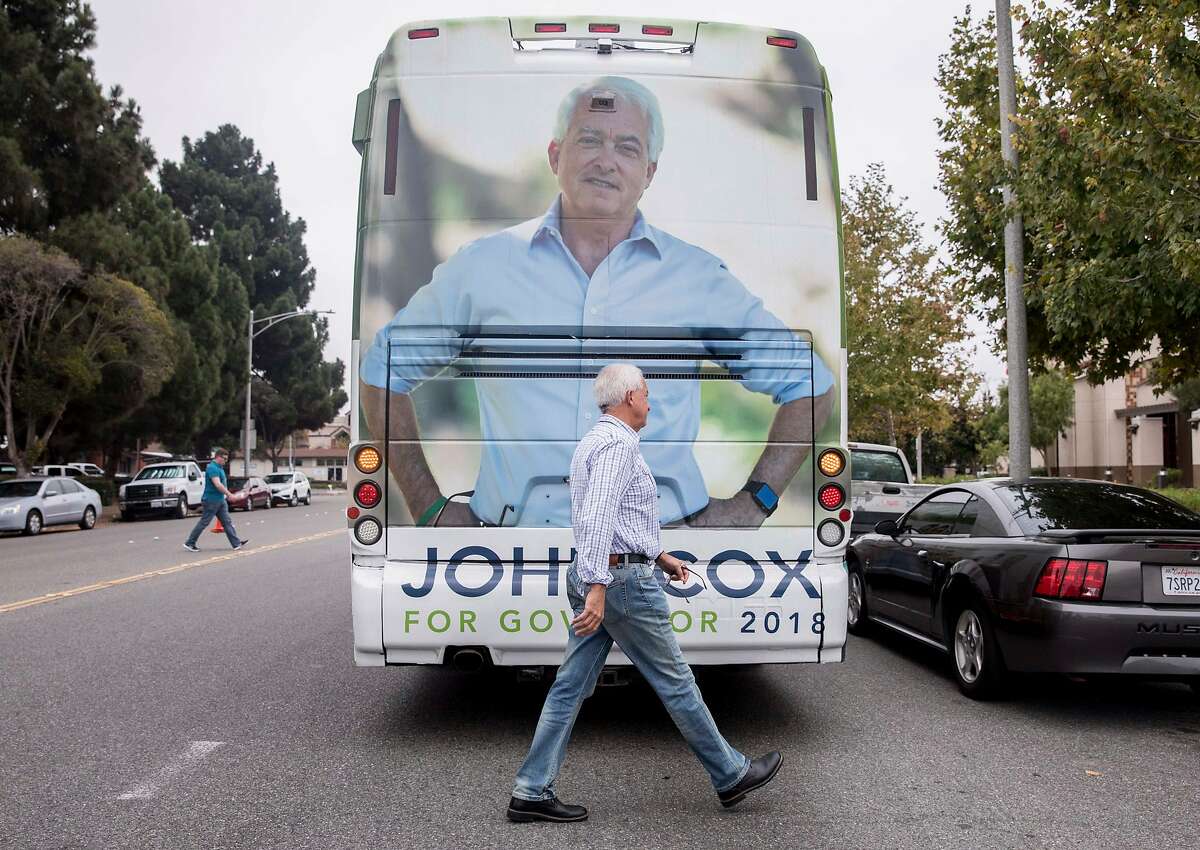 Republican Governor candidate John Cox returns to his campaign bus after a stop on his state-wide tour at the Central Fremont DMV in Fremont, Calif. Friday, Sept. 28, 2018.
