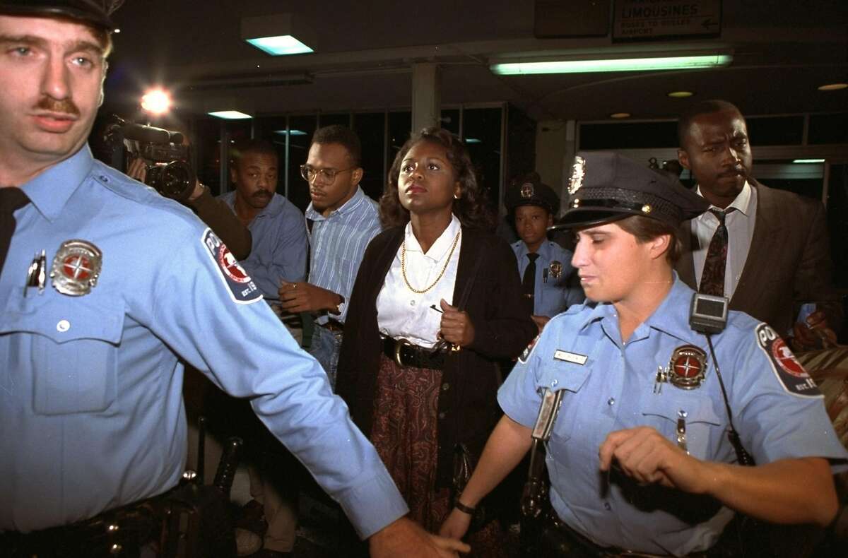 University of Oklahoma law professor Anita Hill, who accused U.S. Supreme Court nominee Judge Clarence Thomas of sexual harassment, leaves Washington's National Airport in Arlington, Va., amid heavy security, Friday, October 10, 1991. Hill was to testify before the Senate Judiciary Committee Friday. (AP Photo/Doug Mills)