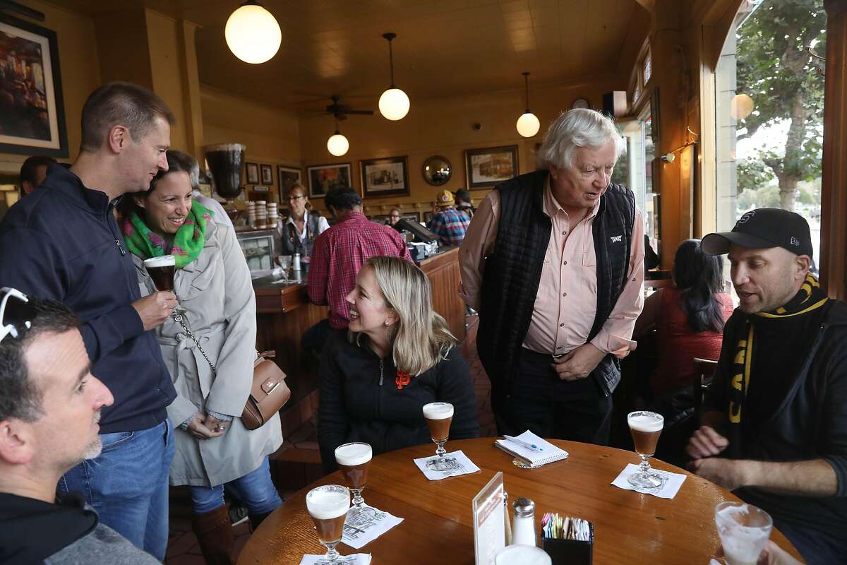 Heather Knight (third from right) talks with William Wemore (second from left) and Shireen Wetmore (third from left) as Peter Hartlaub (right) talks with Bob Freeman, owner The Buena Vista ( second from right) and others joining them for their arrival at the final stop at The Buena Vista on Tourist Trap Day on Wednesday, September 26, 2018 in San Francisco, Calif.