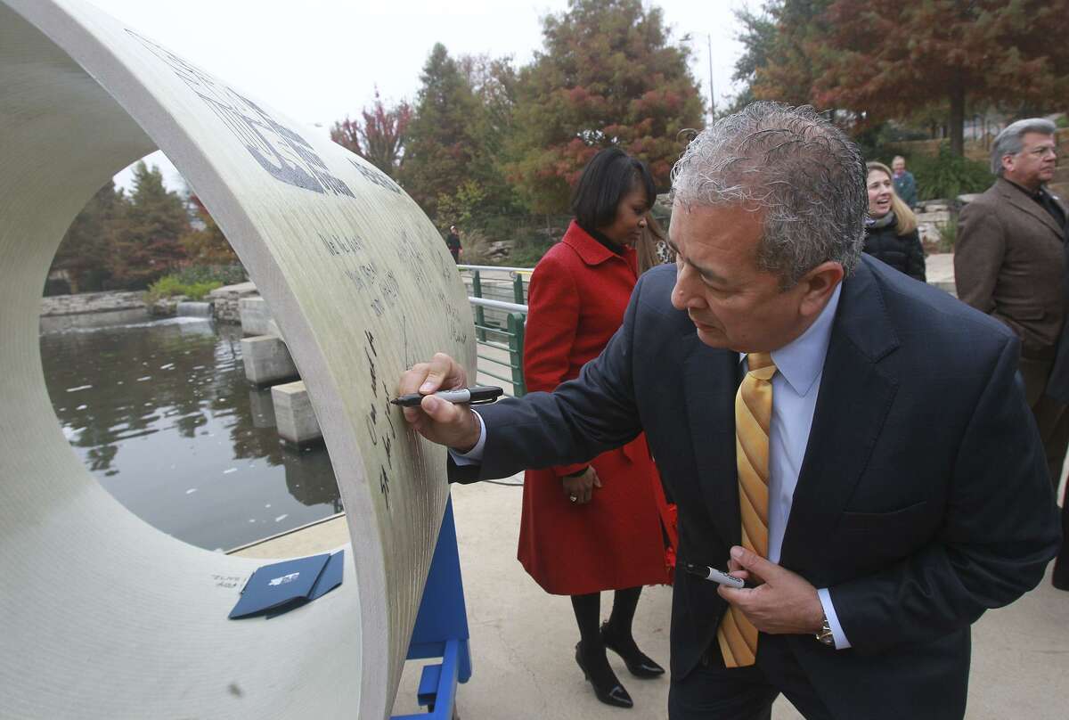 FILE PHOTO: San Antonio Water System president/CEO Robert R. Puente signs a 54-inch diameter pipe Wednesday December 3, 2014 at an event held at the Pearl Amphitheater announcing the launch of the new Vista Ridge water project. The pipe represents the width of the actual pipe used in the first part of the 142-mile pipeline running from Burleson County to San Antonio. According to a press release supplied by SAWS, the Vista Ridge project will convey 16.3 billion gallons of new non-Edwards Aquifer water annually to San Antonio.