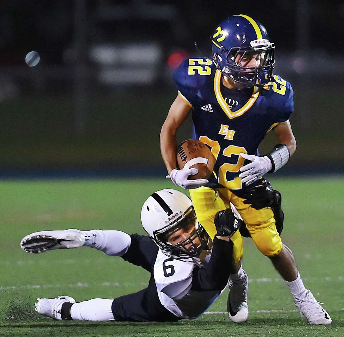 East Haven‘s Jacob Araujo attempts to escape a tackle by Xavier’s Mike Astorino on Friday.