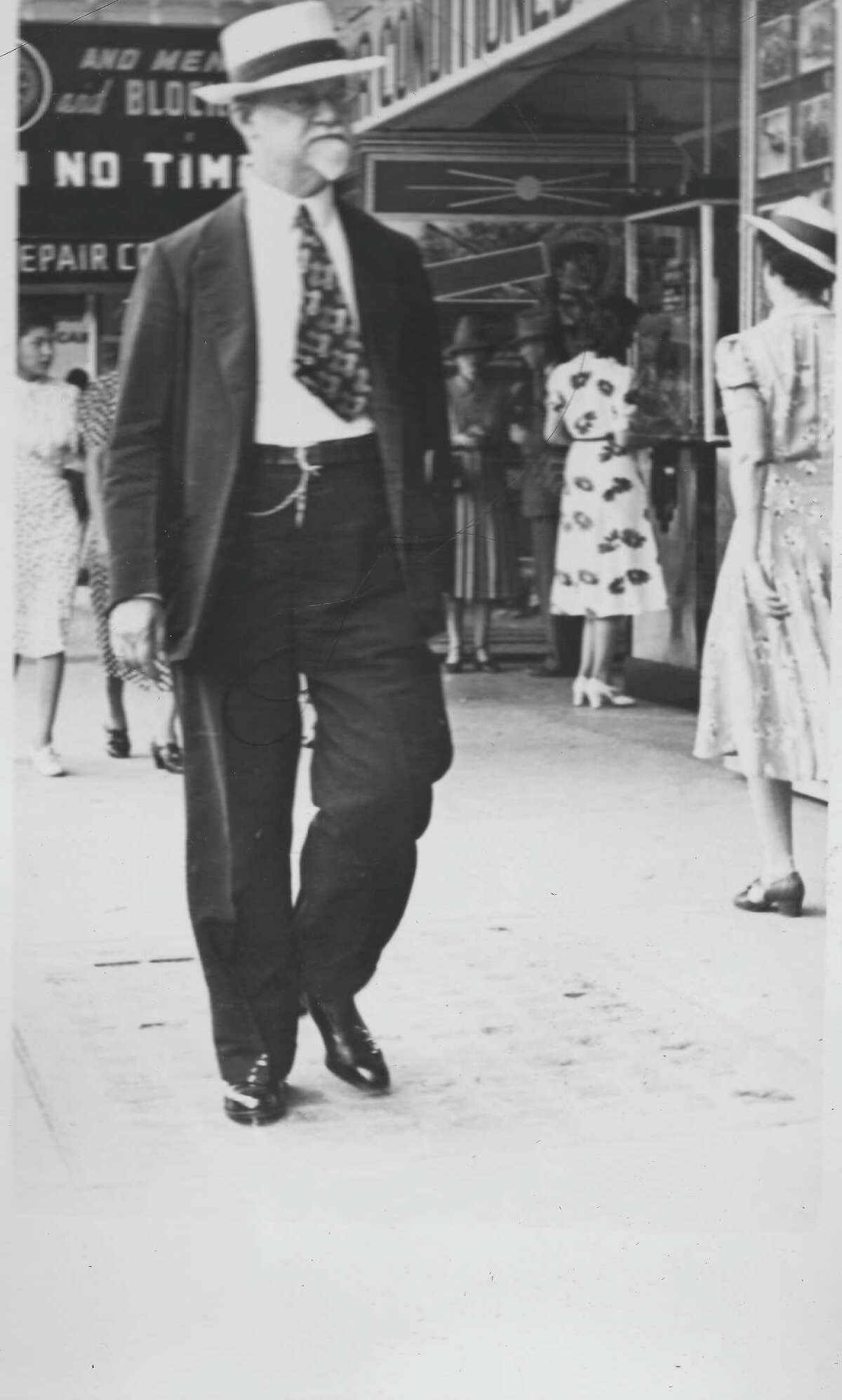 Edward W. Heusinger walks down Houston Street in downtown San Antonio in this undated photo, taken by a street photographer. A prominent businessman and author, Heusinger headed the Committee of 100, a group of volunteer "citizen promoters" who organized San Antonio's 1930 bicentennial, celebrating the city's first civilian government.