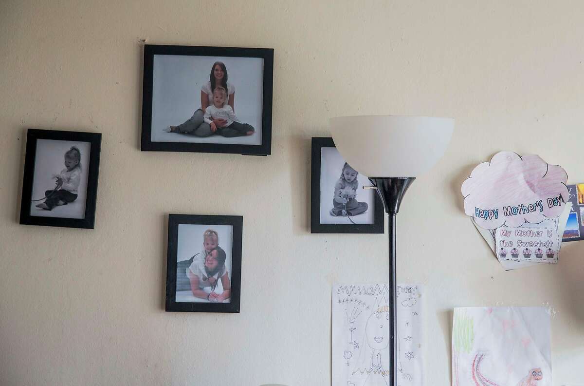 Photos of Crystal Chandler and her daughter sit on the wall next to notes written to her by her daughter at her apartment in Concord, Calif. Saturday, Sept. 29, 2018.