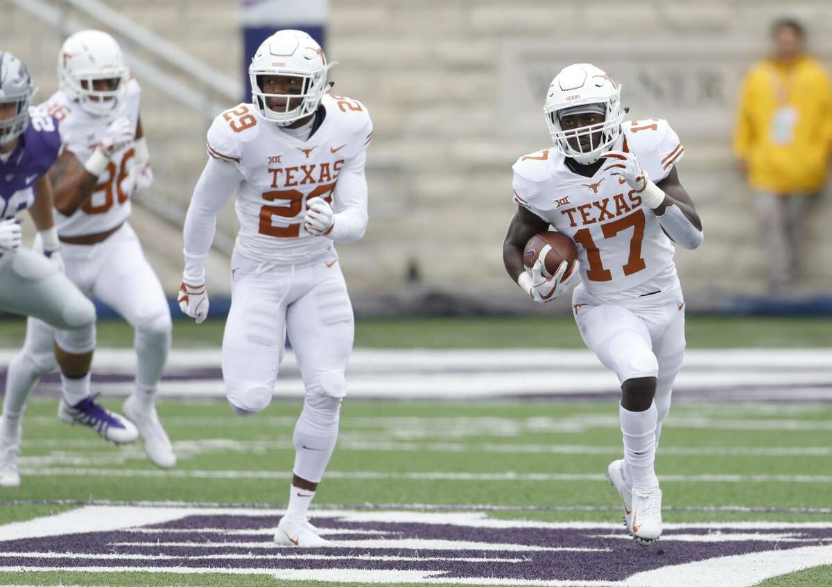 Texas kick returner D'Shawn Jamison (17) returns a Kansas State punt for a touchdown as Josh Thompson (29) provides cover during the first quarter of a college football game in Manhattan, Kan., Saturday, Sept. 29, 2018. (AP Photo/Colin E. Braley)