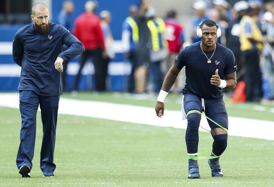 Luke Richesson, the Houston Texans director of sports performance, left, works with Texans quarterback Deshaun Watson as he warms up before an NFL football game against the Indianapolis Colts at Lucas Oil Stadium on Sunday, Sept. 30, 2018, in Indianapolis. Photo: Brett Coomer/Staff Photographer