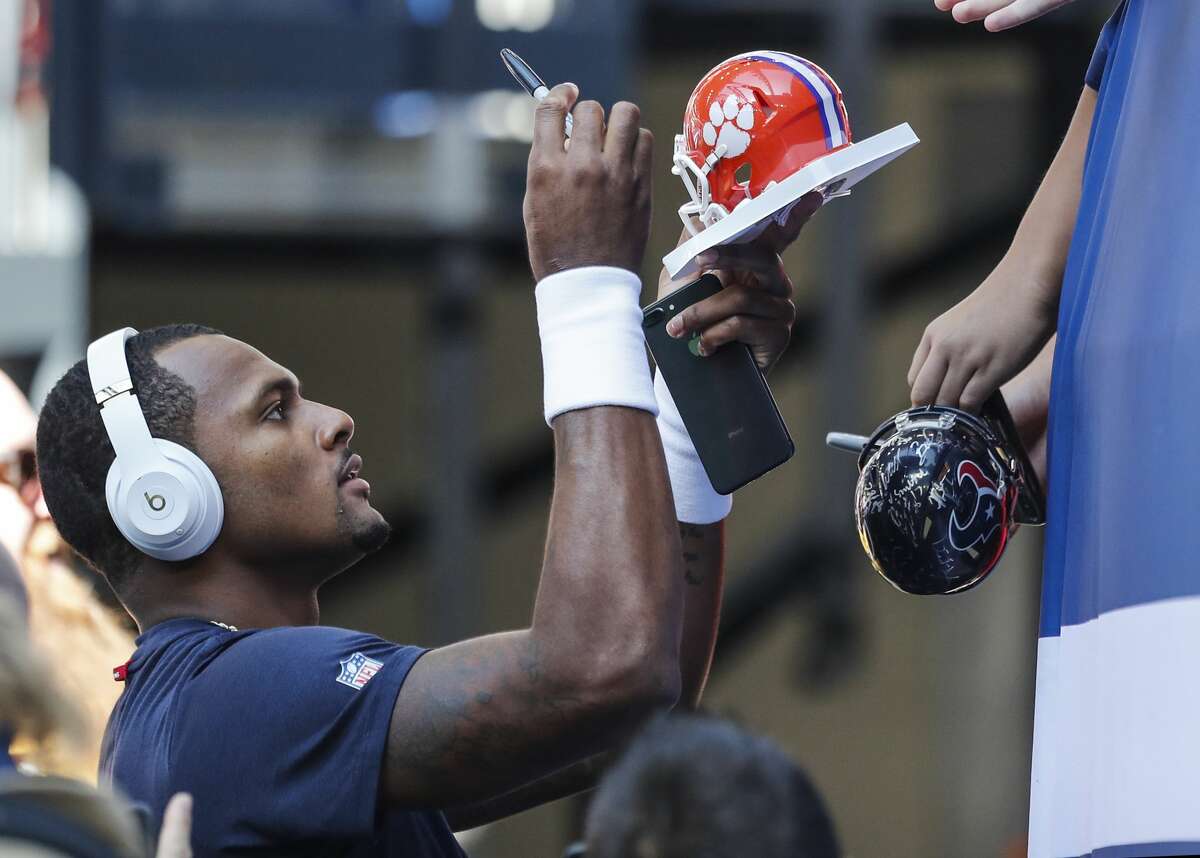 Houston Texans quarterback Deshaun Watson signs autographs before an NFL football game against the Indianapolis Colts wide receiver Deon Cain (8) at Lucas Oil Stadium on Sunday, Sept. 30, 2018, in Indianapolis.