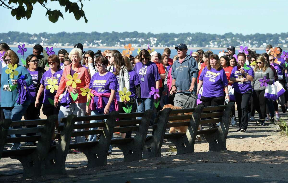 Walkers begin the 2018 Walk to End Alzheimer's at Lighthouse Point Park in New Haven on September 30, 2018. Over 1600 walkers participated carrying flowers to signify their connection to Alzheimer's.