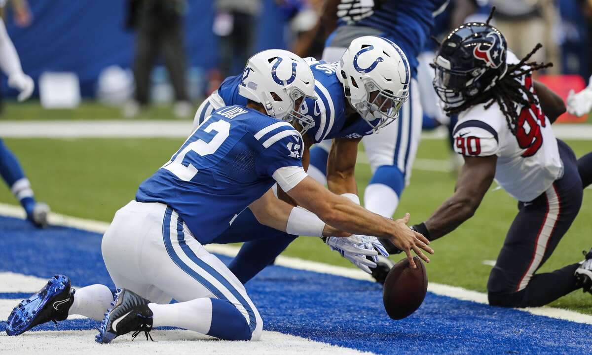 Indianapolis Colts quarterback Andrew Luck (12) fumbles in the end zone and Houston Texans linebacker Jadeveon Clowney (90) comes in and recovers the ball for a touchdown during the first quarter of an NFL football game at Lucas Oil Stadium on Sunday, Sept. 30, 2018, in Indianapolis.